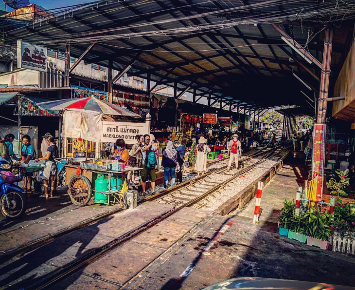 en, maeklong railway market - the most unique train market in bangkok