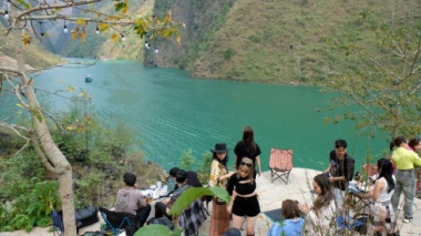 Busy tourists sailing across the deepest gorge in Southeast Asia in Ha Giang