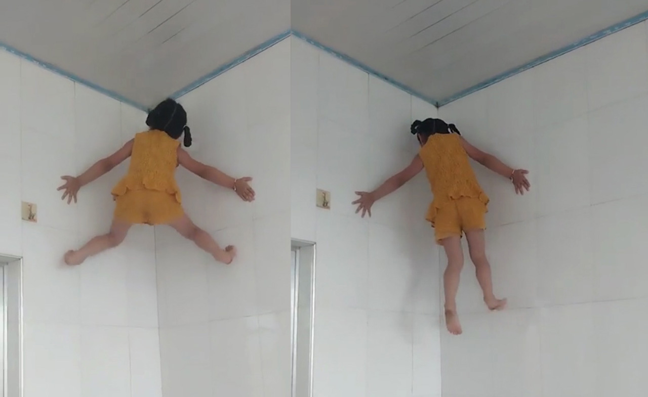 Bé gái Trung Quốc trèo tường như người nhện